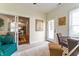 A bright sunroom featuring neutral carpet, dining table, and access to the patio via a white door and sliding glass door at 564 Parkhurst Ct, Greenwood, IN 46142