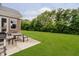 Backyard with a patio, outdoor seating, and a view of the green lawn and surrounding trees at 5706 Bentbrook Dr, Bargersville, IN 46106