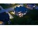 A nighttime aerial view of a two-story home showcasing backyard living space at 5706 Bentbrook Dr, Bargersville, IN 46106