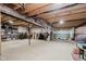 Unfinished basement with exposed ceiling beams, concrete floor, and ample space for storage or customization at 5706 Bentbrook Dr, Bargersville, IN 46106