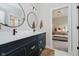 Charming bathroom with double sinks, modern fixtures, and a doorway to the primary bedroom at 5706 Bentbrook Dr, Bargersville, IN 46106