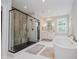 The primary bathroom features a glass shower, soaking tub, and modern fixtures for a luxurious feel at 5706 Bentbrook Dr, Bargersville, IN 46106