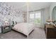 Stylish bedroom with floral wallpaper, a canopy bed, and a comfortable seating area with natural light at 5706 Bentbrook Dr, Bargersville, IN 46106