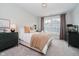 Cozy bedroom featuring neutral tones, a plush bed with decorative pillows, and an eye-catching light fixture at 5706 Bentbrook Dr, Bargersville, IN 46106
