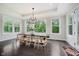 Dining room with large windows, hardwood floors, modern chandelier, and wood table with seating at 5706 Bentbrook Dr, Bargersville, IN 46106