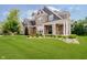 A beautiful home with a stone facade, white columns, manicured lawn, and professional landscaping at 5706 Bentbrook Dr, Bargersville, IN 46106
