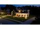 A home with a stone facade, covered entry, and manicured landscaping, captured in an aerial shot at night at 5706 Bentbrook Dr, Bargersville, IN 46106