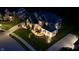 An aerial night view of a home with a brick and stone facade, illuminated landscaping and dark roof at 5706 Bentbrook Dr, Bargersville, IN 46106