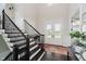 Grand two story foyer features hardwood floors, a dark wood staircase, and view of a double door entry at 5706 Bentbrook Dr, Bargersville, IN 46106