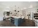 Gourmet kitchen with island seating, stainless steel appliances and open view to the adjacent living room at 5706 Bentbrook Dr, Bargersville, IN 46106
