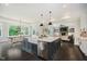 Open kitchen with a view to a dining space and living space, an oversized island and lots of natural light at 5706 Bentbrook Dr, Bargersville, IN 46106