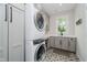 Well-appointed laundry room boasts stylish tile flooring, modern appliances, and plenty of storage at 5706 Bentbrook Dr, Bargersville, IN 46106