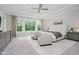 This main bedroom features a tray ceiling, large windows, sitting area, and neutral decor at 5706 Bentbrook Dr, Bargersville, IN 46106