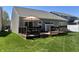 View of wooden deck with dark railings, green lawn, and neutral-colored siding at 5932 Edelle Dr, Indianapolis, IN 46237