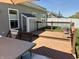 Backyard deck with dining area, wooden railing, and green lawn overlooking backyard at 5932 Edelle Dr, Indianapolis, IN 46237