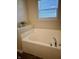 Relaxing bathtub with a large window and a sleek faucet at 5932 Edelle Dr, Indianapolis, IN 46237