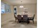 Formal dining room with a wooden table, upholstered chairs, and a decorative chandelier at 5932 Edelle Dr, Indianapolis, IN 46237
