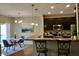 Eat-in kitchen with dark cabinets, stainless steel appliances, granite countertops, and breakfast bar at 5932 Edelle Dr, Indianapolis, IN 46237
