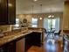 Well-equipped kitchen with dark cabinetry, stainless steel appliances, and a view of the living area at 5932 Edelle Dr, Indianapolis, IN 46237