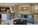 Open-concept living area with kitchen view, breakfast bar seating, and neutral decor at 5932 Edelle Dr, Indianapolis, IN 46237