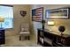 Bright office space with a comfortable chair, decorative flag, and framed art prints at 5932 Edelle Dr, Indianapolis, IN 46237