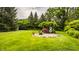 Expansive backyard featuring lush green lawn and a charming pergola-covered seating area at 6295 N Olney St, Indianapolis, IN 46220