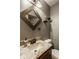 Well-lit bathroom with modern sink, granite countertop, and dark wood framed mirror at 6295 N Olney St, Indianapolis, IN 46220