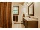 Updated bathroom with marble countertop, shower, and window providing natural light at 6295 N Olney St, Indianapolis, IN 46220