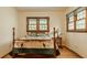 Bedroom featuring wood floors, two windows, and a vintage bed with custom bedding at 6295 N Olney St, Indianapolis, IN 46220