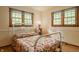 Bedroom with bright natural light from two windows and a vintage style bed at 6295 N Olney St, Indianapolis, IN 46220