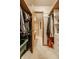 View from closet through a doorway leading to a bathroom with sink and tiled floors at 6295 N Olney St, Indianapolis, IN 46220
