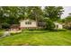 Charming home exterior with well-maintained lawn and mature trees offering privacy and curb appeal at 6295 N Olney St, Indianapolis, IN 46220