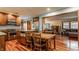 Open concept kitchen boasts wood cabinets, stainless steel appliances, granite countertops, and hardwood floors at 6295 N Olney St, Indianapolis, IN 46220