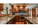 A spacious kitchen features granite countertops, wood cabinets, and stainless steel appliances at 6295 N Olney St, Indianapolis, IN 46220