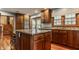 Kitchen with a large island, wood cabinets, stainless steel appliances, and eat in dining at 6295 N Olney St, Indianapolis, IN 46220