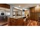 Open concept kitchen with granite island, stainless steel appliances, and wood floors at 6295 N Olney St, Indianapolis, IN 46220