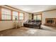 Comfortable living room with a fireplace, and a large sofa under a window at 6295 N Olney St, Indianapolis, IN 46220