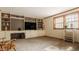 Spacious living room with built-in shelving and cabinetry and a window with blinds at 6295 N Olney St, Indianapolis, IN 46220