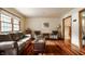 Bright living room featuring hardwood floors, a comfortable sofa and large window at 6295 N Olney St, Indianapolis, IN 46220