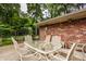 Outdoor patio shows an outdoor dining set, brick wall, and view of the backyard at 6295 N Olney St, Indianapolis, IN 46220