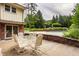 Outdoor patio features a dining set next to the house and the pool, perfect for entertaining at 6295 N Olney St, Indianapolis, IN 46220