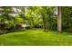 Sprawling lawn with mature trees and professionally landscaped garden leading up to the residence at 6295 N Olney St, Indianapolis, IN 46220
