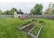 Backyard with three wooden beds and a grass yard at 63 Longfellow Ln, Greenfield, IN 46140