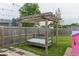 Backyard swing with a wooden beam and patio at 63 Longfellow Ln, Greenfield, IN 46140