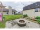 Backyard with a brick fire pit and a grass yard at 63 Longfellow Ln, Greenfield, IN 46140