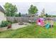 Spacious backyard with a fire pit, playhouse, and swing at 63 Longfellow Ln, Greenfield, IN 46140