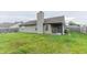 Backyard with a stone chimney and a lawn at 63 Longfellow Ln, Greenfield, IN 46140