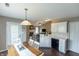 Open-concept kitchen offering white cabinets, black appliances, and views into the living area at 63 Longfellow Ln, Greenfield, IN 46140