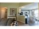 Open-concept living room that flows into the kitchen with white cabinets and stainless steel appliances at 63 Longfellow Ln, Greenfield, IN 46140