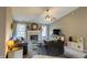 Inviting living room boasts a fireplace, ceiling fan, neutral color palette, and cozy furnishings at 63 Longfellow Ln, Greenfield, IN 46140